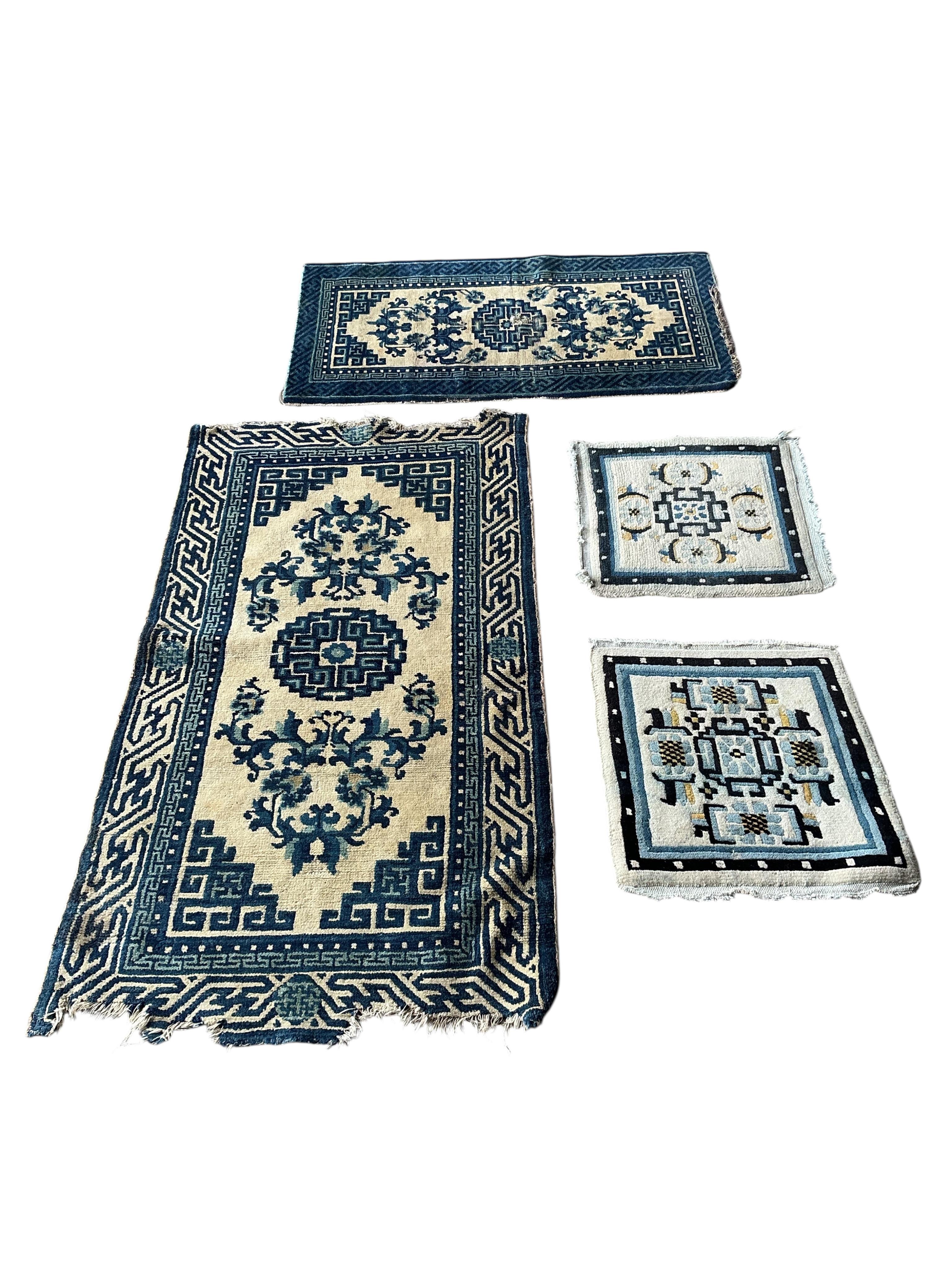 Two Sino-Tibetan ivory ground rugs, 19th century and two Tibetan ivory ground square mats, largest 120 x 66cm